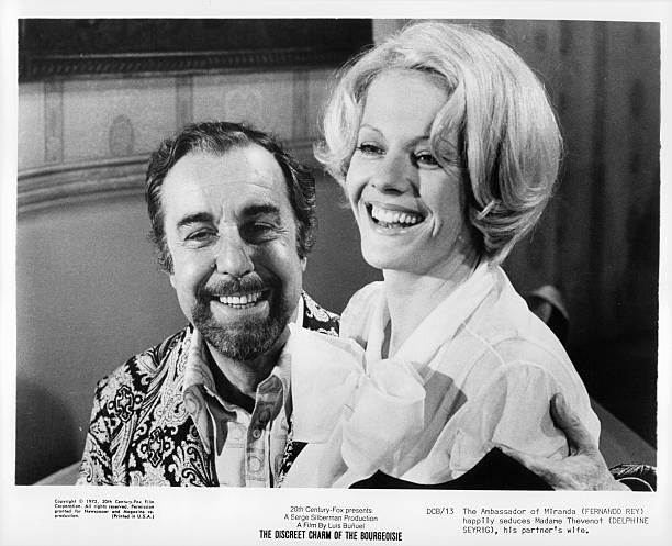 Fernando Rey with Delphine Seyrig on his lap in a scene from the film 'The Discreet Charm of The Bourgeoisie', 1972. (Photo by 20th Century-Fox/Getty Images)